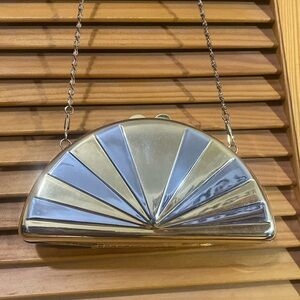 Reflective, duo-toned semicircle crossbody clutch